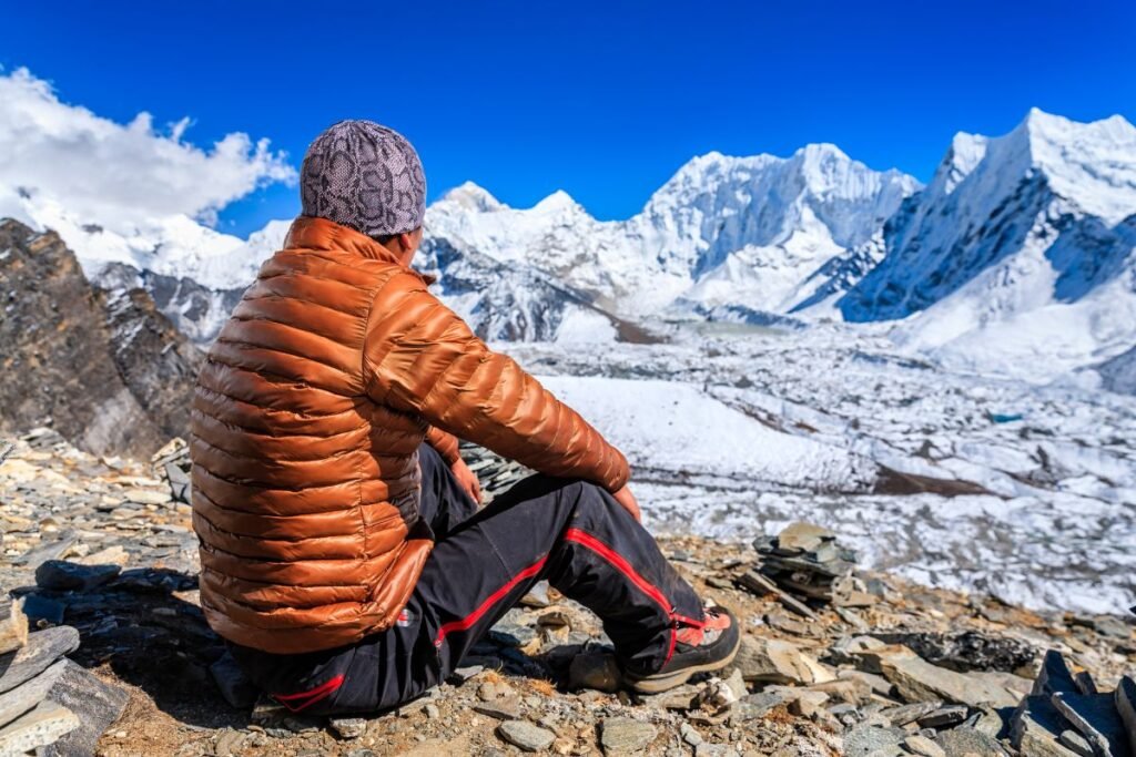 Nepali Sherpa resting and looking at Mount Makalu, Nepal